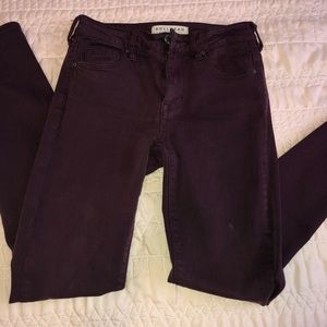 Maroon skinny jeans with ripped knees